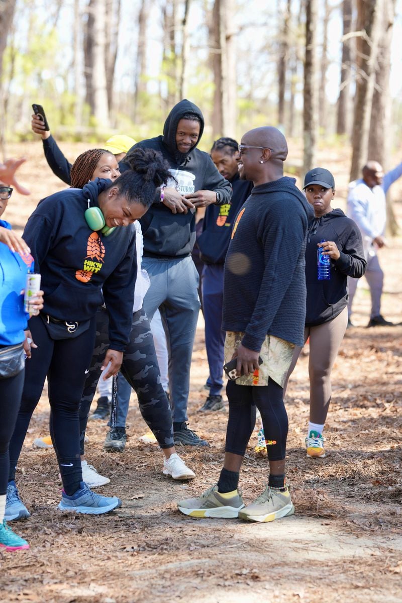 Rashad "Big Bank" Holsey, Sr. talks with participants of one of his monthly hosted "Hik'n Wit Bank" community hiking events in various locations in greater Atlanta.