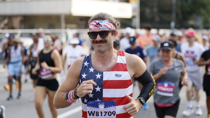 Peachtree runner shows patriotic spirit at the start of the 55th running of the Atlanta Journal-Constitution Peachtree Road Race in Atlanta on Thursday, July 4, 2024.   (Miguel Martinez / AJC)