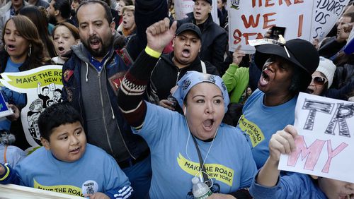 Immigrants and supporters protest against President-elect Donald Trump during a march, Sunday, Nov. 13, 2016, in New York. Immigrants and their advocates added their voices on Sunday to those who have been marching and protesting Donald Trump's presidential win. Organizers said the protest scheduled for Sunday mid-afternoon in Manhattan is about speaking out against Trump's support of deportation and other measures. (AP Photo/Mark Lennihan)