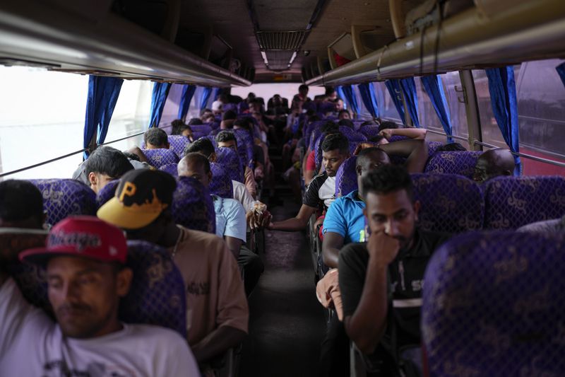 Migrants sit on a northbound bus heading to Costa Rica as they wait to leave Lajas Blancas, Panama, Thursday, Sept. 26, 2024, after walking across the Darien Gap from Colombia in hopes of reaching the U.S. (AP Photo/Matias Delacroix)