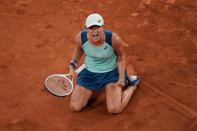 FILE - Poland's Iga Swiatek reacts as she defeats Coco Gauff of the U.S. during the women final match of the French Open tennis tournament at Roland Garros stadium Saturday, June 4, 2022, in Paris. Swiatek won 6-1, 6-3. Swiatek has been No. 1 in the WTA rankings for most of the past two years and will seek her fourth championship at Roland Garros — and fifth Grand Slam trophy overall — when play begins at the clay-court major tournament Sunday. (AP Photo/Christophe Ena, File)