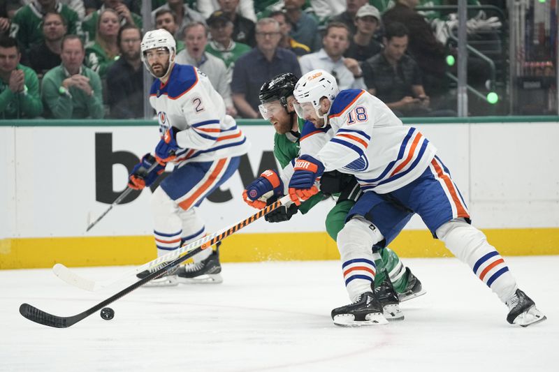 Edmonton Oilers left wing Zach Hyman (18) and Dallas Stars center Joe Pavelski (16) compete for control of the puck during the first period of Game 1 of the Western Conference finals in the NHL hockey Stanley Cup playoffs Thursday, May 23, 2024, in Dallas. (AP Photo/Tony Gutierrez)
