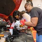 Lorelei Neighbors and Vanessa Walker use a voltage meter on a car at Savannah Technical College on Tuesday, July 16, 2024 in Savannah, GA. (AJC Photo/Katelyn Myrick)