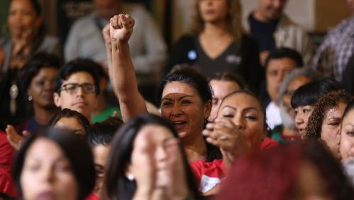 Will these folks remain happy when they learn the unions want to negotiate their wages downward? (AP Photo / Damian Dovarganes)