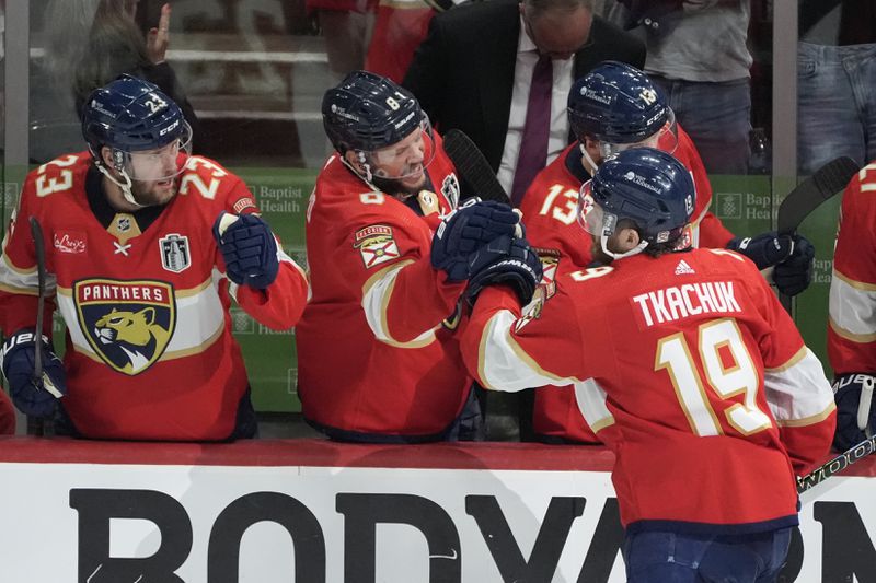 Florida Panthers left wing Matthew Tkachuk (19) is congratulated by teammates after scoring a goal during the second period of Game 5 of the NHL hockey Stanley Cup Finals against the Edmonton Oilers, Tuesday, June 18, 2024, in Sunrise, Fla. (AP Photo/Rebecca Blackwell)