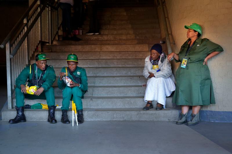 African National Congress Marshalls take a break as South African President Cyril Ramaphosa speaks at the Siyanqoba rally at FNB stadium in Johannesburg, South Africa, Saturday, May 25, 2024. South African will vote in the 2024 general elections May 29. (AP Photo/Jerome Delay)