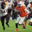 Miami quarterback Cam Ward (1) runs for a touchdown during the second half of an NCAA college football game against Virginia Tech , Friday, Sept. 27, 2024, in Miami Gardens, Fla. (AP Photo/Marta Lavandier)