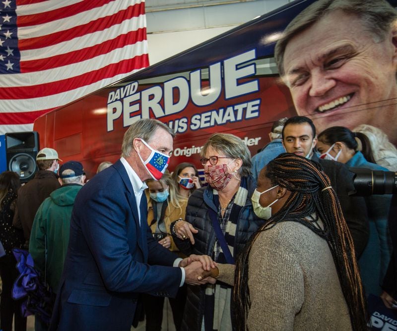 Senator David Perdue holds a rally at Peachtree DeKalb Airport with SC Senator Tim Scott and meets some of his supporters Monday, Nov 2, 2020.  (Jenni Girtman for The Atlanta Journal-Constitution)