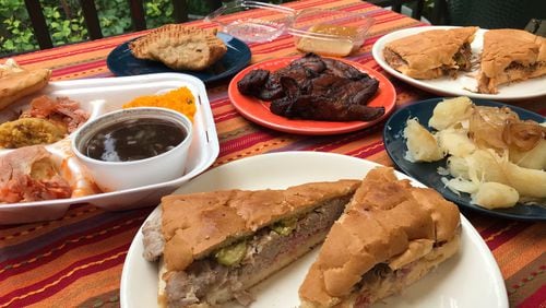 Havana Sandwich Shop specializes in affordably priced Cuban classics. Pictured, clockwise from left, are a tamale plate, empanadas, maduros (sweet fried plantains), flan, a ropa vieja sandwich, yuca con mojo and a Cuban sandwich. LIGAYA FIGUERAS/LIGAYA.FIGUERAS@AJC.COM