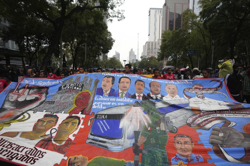 Families and friends take part in a demonstration marking the 10-year anniversary of the disappearance of 43 students from an Ayotzinapa rural teacher's college, in Mexico City, Thursday, Sept. 26, 2024. (AP Photo/Fernando Llano)