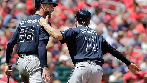 Mike Foltynewicz and Ender Inciarte celebrate after scoring on a triple by teammate Erick Aybar in the second.