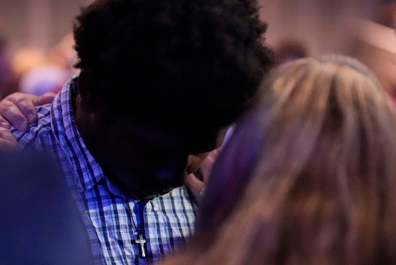 An Apalachee High School student, left, is embraced during a Sunday service at Bethlehem Church, Sunday, Sept. 8, 2024, in Bethlehem, Ga. Colt Gray, 14, has been charged with murder over the killing of two students and two teachers at Apalachee High School in Barrow County, outside Atlanta, on Wednesday. (AP Photo/Mike Stewart)