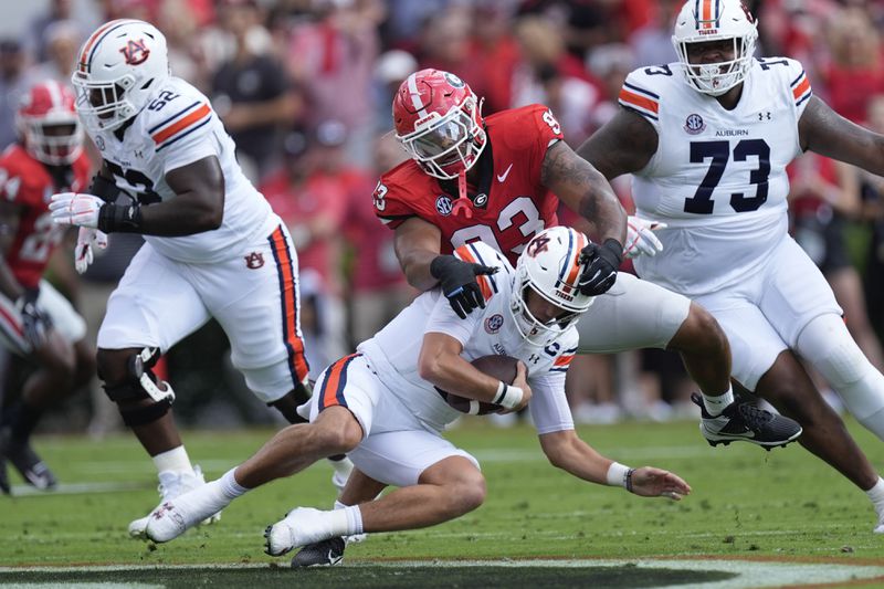 Auburn quarterback Payton Thorne (1) is sacked by Georgia defensive lineman Tyrion Ingram-Dawkins (93) in the first half of an NCAA college football game Saturday, Oct. 5, 2024, in Athens, Ga. (AP Photo/John Bazemore)