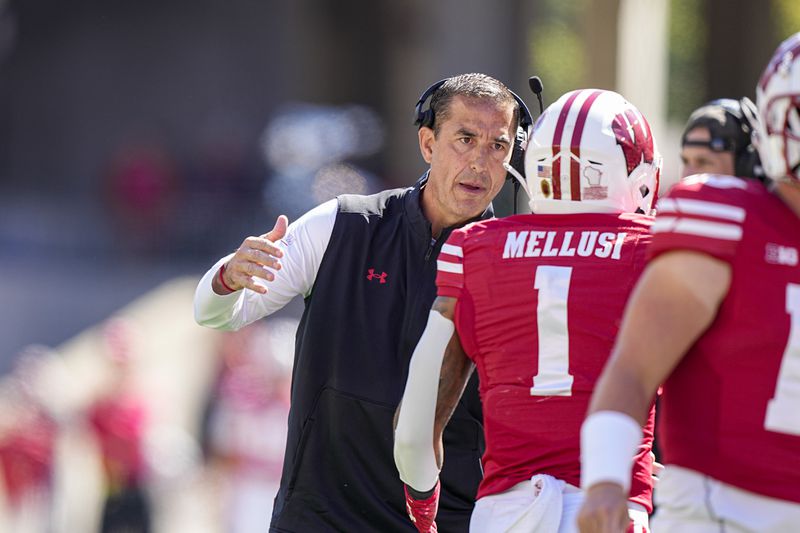 Wisconsin coach Luke Fickell congratulates running back Chez Mellusi after scoring a touchdown against South Dakota during the first half of an NCAA college football game Saturday, Sept. 7, 2024, in Madison, Wis. (AP Photo/Andy Manis)