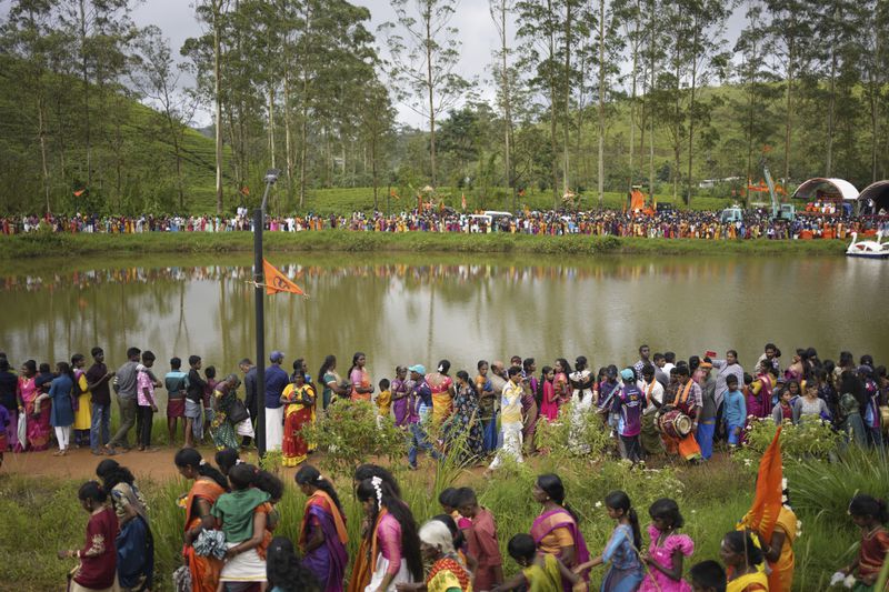 Tea plantation workers and their children take part in a Hindu religious procession in Hatton, Sri Lanka, Sunday, Sept. 8, 2024. (AP Photo/Eranga Jayawardena)