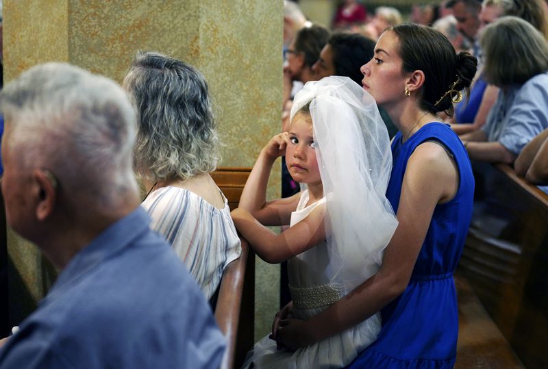 Families attend a prayer service as a part of the National Eucharistic Pilgrimage at St. Peter Church in Steubenville, Ohio, Friday, June 21, 2024. (AP Photo/Jessie Wardarski)