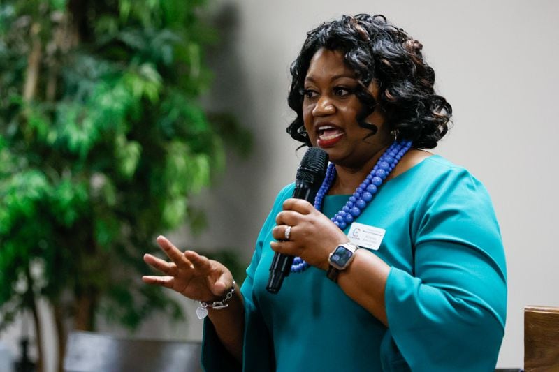 Attania Jean-Funny, who is running for Commissioner District 3, addresses her platform as she speaks to Clayton County residents during a forum organized by Women of Clayton County at Harvest Baptist Tabernacle Church on Thursday, June 6. (Miguel Martinez / AJC)