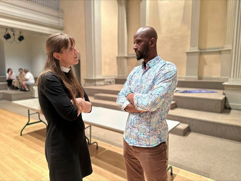 Mamadou Diallo, 39, of Senegal, speaks with Rev. Anne Marie Witchger at St. Mark's Church-in-the-Bowery, Wednesday, May 22, 2024, a lower Manhattan Episcopal church that operates a "welcome center" for migrants on Wednesdays. (AP Photo/Philip Marcelo)