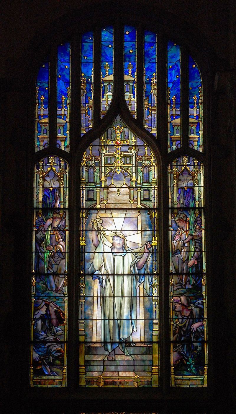 The "Resurrection" window at First Presbyterian Church of Atlanta is by Tiffany and was the first one installed at the church. It shows Jesus walking out of the tomb. On the left and right panels, Roman soldiers cower and disciples bear flowers.