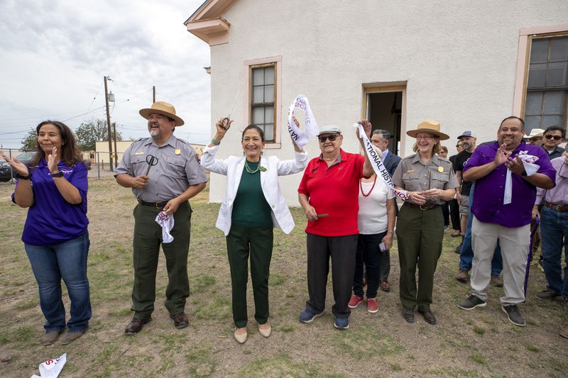 Secretary of the Interior Deb Haaland, center left, Blackwell School alumni Joe Cabezuela, center right, National Park Service Director Chuck Sams, second from left, and NPS Intermountain Regional Director Kate Hammond, second from right, react after cutting the ribbon to inaugurate Blackwell School as the newest National Historic Site in Marfa, Texas, Saturday, Sept. 14, 2024. (AP Photo/Andres Leighton)