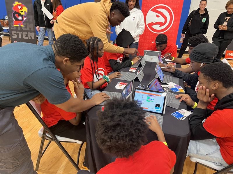 During the challenge, students were asked to create a customized basketball dunk, using a coding program. Clint Capela, Atlanta Hawks center, attended the event and worked with students on their various dunks.