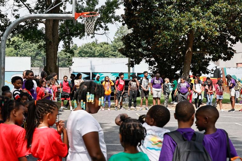 Students in the Camp Best Friend Summer Program line up around the court for the ribbon cutting for the new basketball court at Pittman Park on Wednesday, July 13, 2022. The court will be a part of Mayor Andre Dickens’ Midnight Basketball initiative created to give youth a place to spend time. (Natrice Miller/natrice.miller@ajc.com)