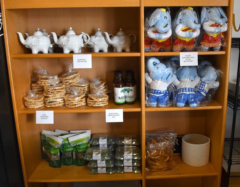Items for sale at the register of Snackboxe Bistro include elephant plush toys, elephant teapots, rice crackers and Snackboxe Bistro's own goods: Crispy Crunch seaweed and bite-sized pandan brownies. (CHRIS HUNT FOR THE ATLANTA JOURNAL-CONSTITUTION)