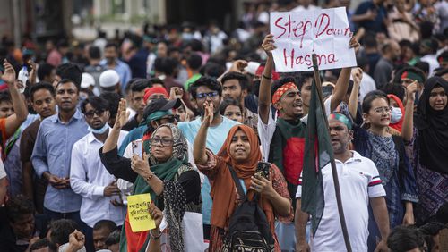 People shout slogans as they take part in a protest against Prime Minister Sheikh Hasina and her government demanding justice for the victims killed in the recent countrywide deadly clashes, in Dhaka, Bangladesh, Monday, Aug. 5, 2024. (AP Photo/Rajib Dhar)