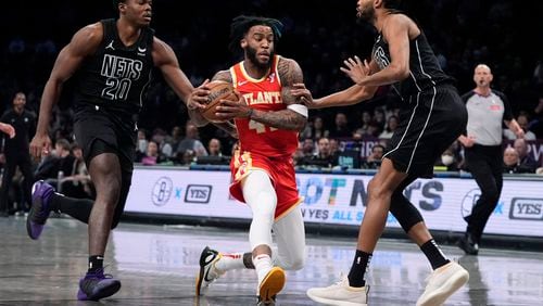 Forward Saddiq Bey has been a force for the Hawks in the paint this season. Here he drives past Day'Ron Sharpe (20) and Mikal Bridges of the Nets during the first half of the Hawks-Nets game Feb. 29, 2024, in New York. (AP Photo/Frank Franklin II)