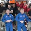 In this image made from a NASA livestream, the two astronauts stuck at the International Space Station since June 2024, Butch Wilmore, far left, and Suni Williams, far right, welcome two new residents who flew up on SpaceX, NASA's Nick Hague, front left in blue, and the Russian Space Agency's Alexander Gorbunov, front right in blue, Sunday, Sept. 29, 2024. Behind them, from left in black, are NASA's Jeanette Epps, Russia's Alexander Grebenkin, NASA's Mike Barratt and NASA's Matthew Dominic. From left, wearing red, are Russia's Ivan Vagner, NASA's Don Pettit and Russia's Alexei Ovchinin. (NASA via AP)