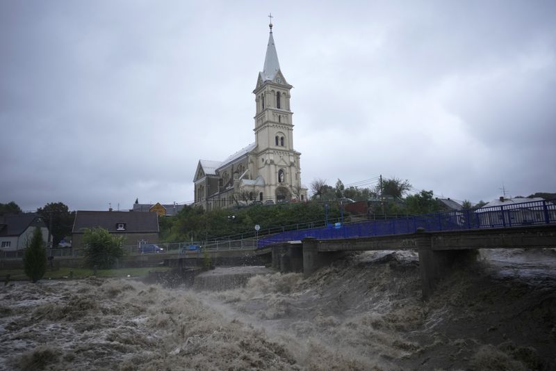 The Bela River flows past a church during floods in Mikulovice, Czech Republic, Saturday, Sept. 14, 2024. (AP Photo/Petr David Josek)