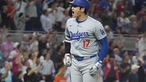 Los Angeles Dodgers' Shohei Ohtani (17) reacts after hitting his 50th home run of the season during the seventh inning of a baseball game against the Miami Marlins, Thursday, Sept. 19, 2024, in Miami. (AP Photo/Marta Lavandier)