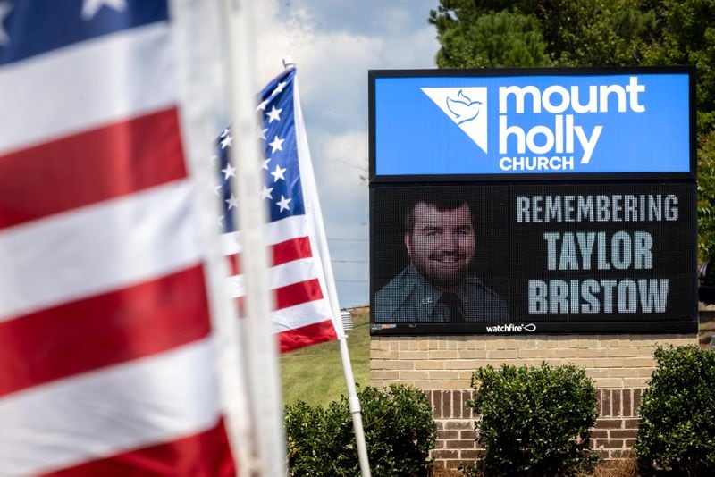 A sign at Mount Holly Church marks the funeral for Carroll County Investigator Taylor Bristow in Carrollton on Thursday. The deputy was shot while serving a warrant and died from his injuries. (Arvin Temkar / AJC)