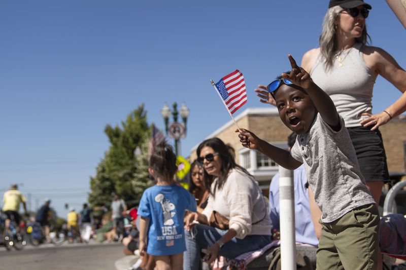 Asa Walden, 4, looks in awe as he waves an American flag during the annual Fourth of July Parade in Alameda, Calif. on Thursday, July 4, 2024. (Minh Connors/San Francisco Chronicle via AP)
