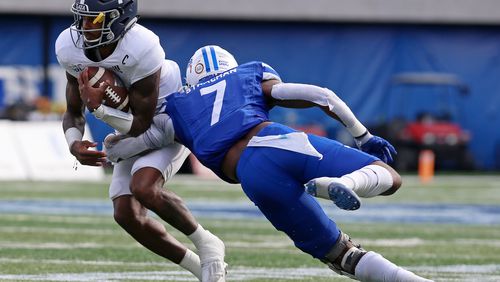 Jordan Strachan (right), outside linebacker for Georgia State, tackles Shai Werts (left), quarterback for Georgia Southern, during the Georgia State University vs. Georgia Southern University football game on Saturday, November 28, 2020, at Georgia State University Stadium in Atlanta. Georgia State defeated Georgia Southern 30-24. CHRISTINA MATACOTTA FOR THE ATLANTA JOURNAL-CONSTITUTION