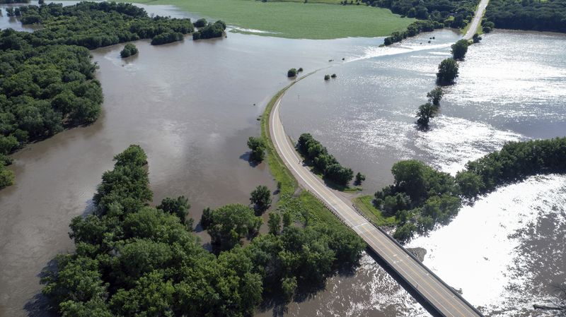 Madison St, is underwater on after days of heavy rain led to flooding in the area, Saturday, June 22, 2024 in Brandon, S.D.. (AP Photo/Josh Jurgens)