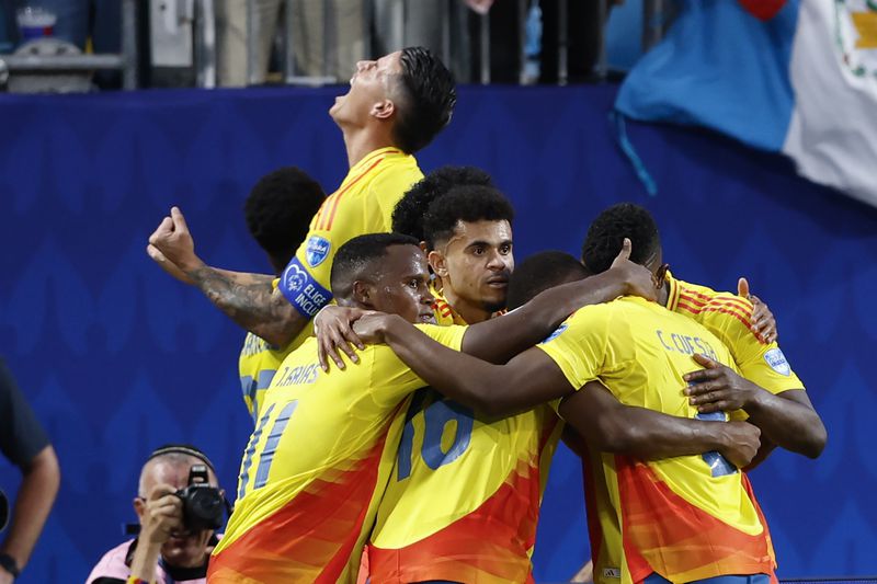 Colombia's players celebrate Jefferson Lerma's goal against Uruguay during a Copa America semifinal soccer match in Charlotte, N.C., Wednesday, July 10, 2024. (AP Photo/Nell Redmond)