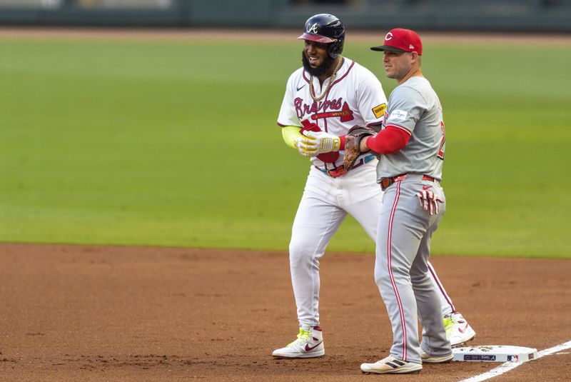 Cincinnati Reds first baseman Ty France, right, covers the base as Atlanta Braves' Marcell Ozuna, left, begins to lead off in the first inning of a make-up baseball game, Monday, Sept. 9, 2024, in Atlanta. (AP Photo/Jason Allen)