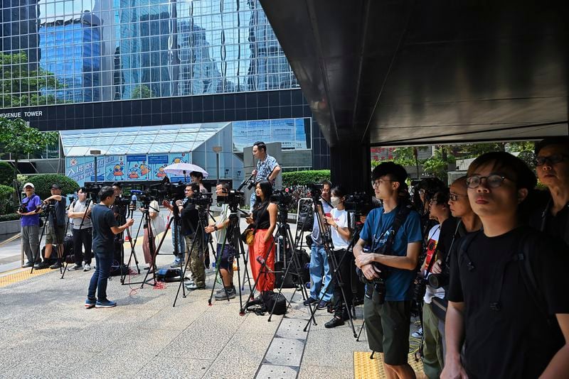 Member of the media wait outside the district court ahead of the verdict on Chung Pui-kuen, the ex-chief editor of the now shuttered Stand News online outlet and his colleague Patrick Lam, former acting chief editor, in Hong Kong on Thursday, Aug. 29, 2024. (AP Photo/Billy H.C. Kwok)