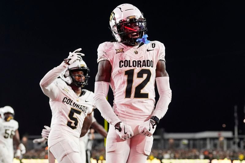 Colorado wide receiver Travis Hunter, right, celebrates after catching a touchdown pass as wide receiver Jimmy Horn Jr. (5) joins in during the second half of an NCAA college football game against Colorado State, Saturday, Sept. 14, 2024, in Fort Collins, Colo. (AP Photo/David Zalubowski)