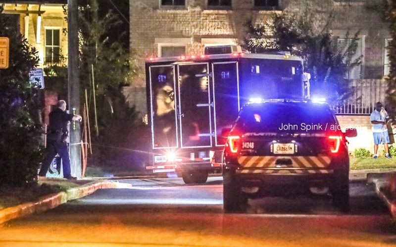 Police worked through the early  morning hours to collect evidence at the Roswell Court Condominiums in Buckhead, where a woman was fatally shot.