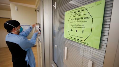 A sign advises medical personnel and visitors to take precautions before entering rooms with patients infected with COVID-19 at the Northeast Medical Georgia Center in Gainesville, GA, on Monday, February 5, 2024.
Miguel Martinez /miguel.martinezjimenez@ajc.com