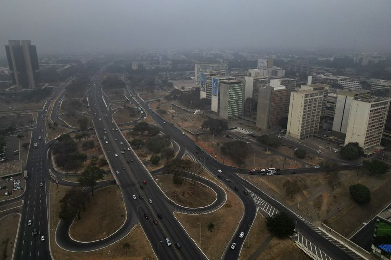 Smoke from wildfires hovers over the city amid dry weather in Brasilia, Brazil, early Monday, Aug. 26, 2024. (AP Photo/Eraldo Peres)