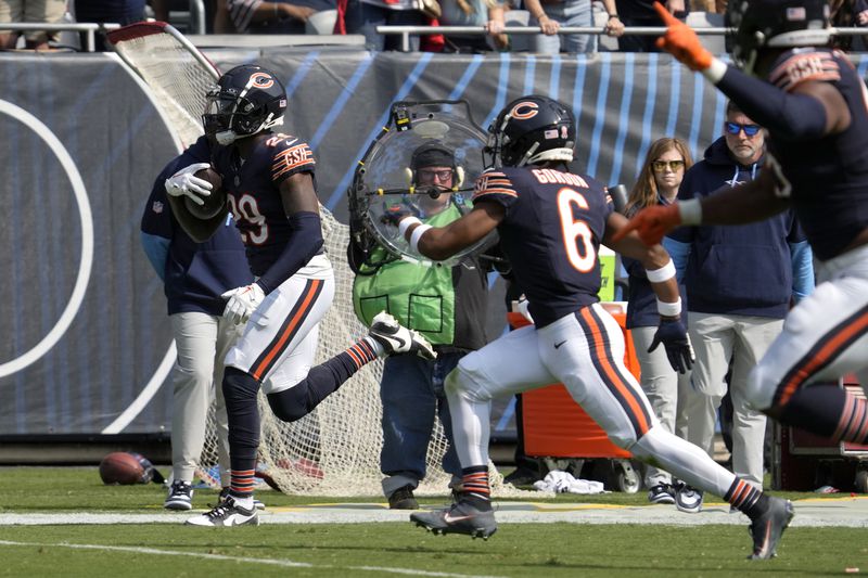 Chicago Bears cornerback Tyrique Stevenson (29) heads to the end zone for a touchdown after intercepting a pass by Tennessee Titans quarterback Will Levis during the second half of an NFL football game Sunday, Sept. 8, 2024, in Chicago. (AP Photo/Nam Y. Huh)