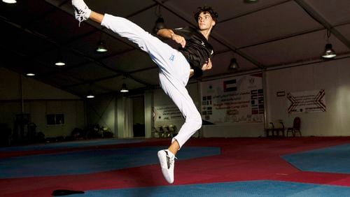 Omar Ismail, who was born in Dubai and will be competing for the Palestinian territories at the Paris Olympics, practices taekwondo in Sharjah, United Arab Emirates, on Thursday, June 20, 2024. (AP Photo/Martin Dokoupil)
