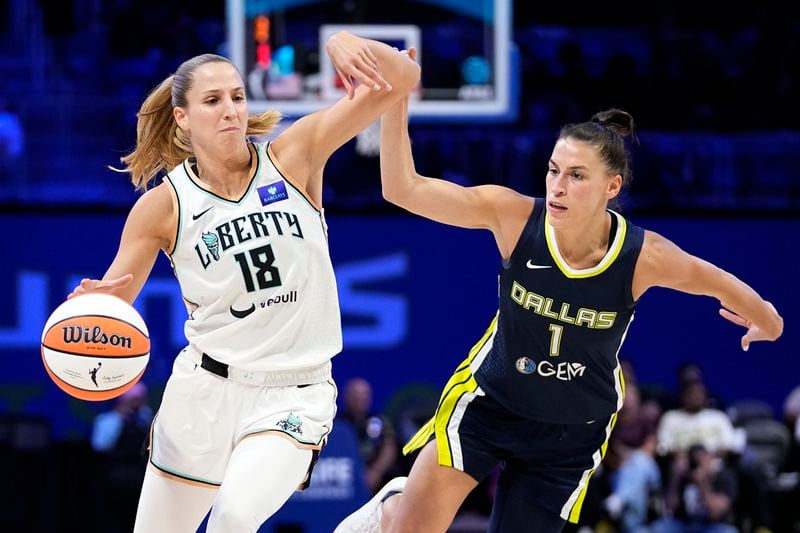 New York Liberty's Ivana Dojkic (18) works against Dallas Wings guard Sevgi Uzun (1) in the second half of a WNBA basketball game, Thursday, Sept. 12, 2024, in Arlington, Texas. (AP Photo/Tony Gutierrez)