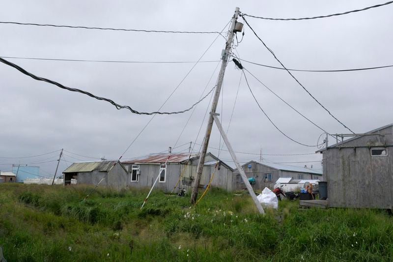 Power poles lean in the village of Newtok, Alaska on Wednesday, Aug. 14, 2024. (AP Photo/Rick Bowmer)