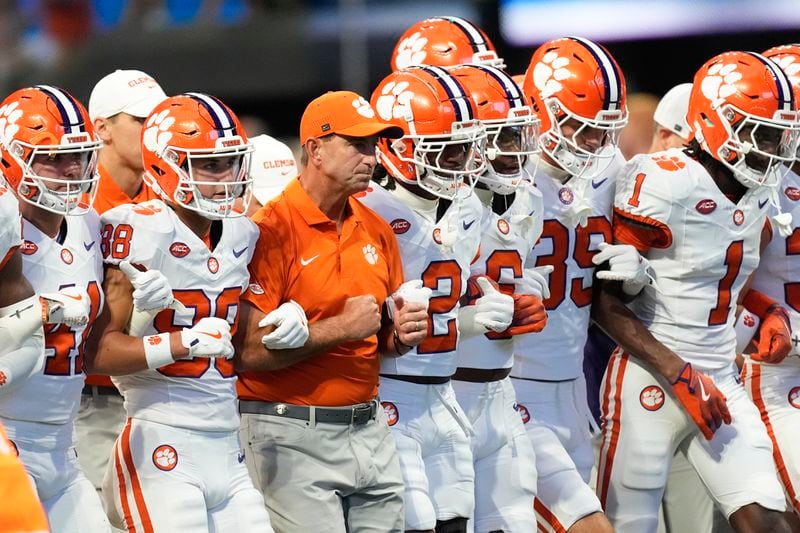 Clemson head coach Dabo Swinney, center, walks with his players before an NCAA college football game againt Georgia Aug. 31, 2024, in Atlanta. (AP Photo/John Bazemore)