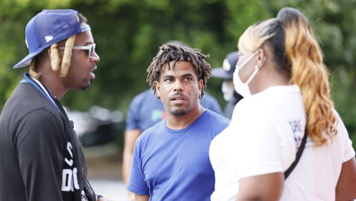 Terence Denson (center) speaks to friends after a peaceful rally at Windsor Plaza, where a gunfight Aug. 7 left two people dead and four injured, including a 6-year-old girl. Denson was shot and killed Thursday night at a Mechanicsville bar.