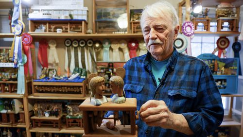 Carwood “Woody” Jones holds one of his wood sculpture prototypes at his home showroom in Decatur. Over 40 years, Jones has produced more than 3,000 pieces of mechanical amusements. (Miguel Martinez /miguel.martinezjimenez@ajc.com)